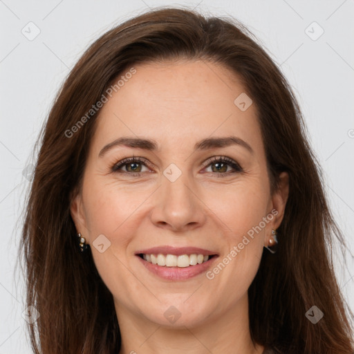 Joyful white adult female with long  brown hair and brown eyes