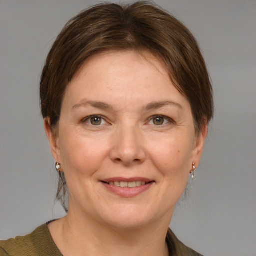 Joyful white adult female with medium  brown hair and grey eyes