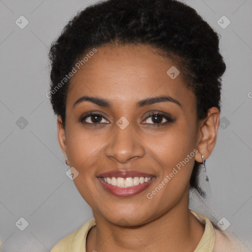 Joyful black young-adult female with short  brown hair and brown eyes