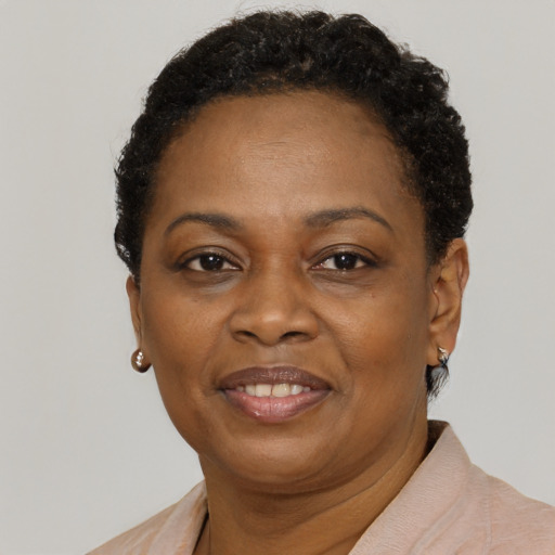 Joyful black adult female with short  brown hair and brown eyes