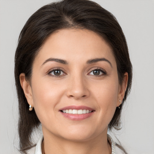 Joyful white young-adult female with medium  brown hair and brown eyes