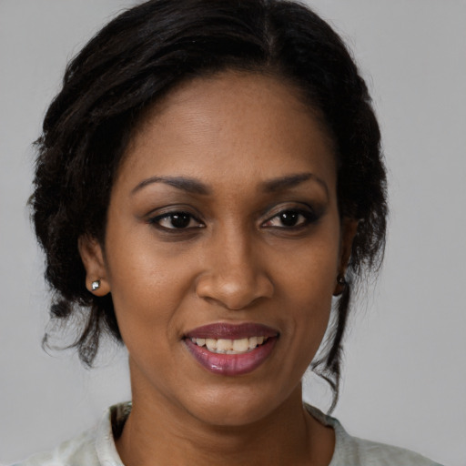 Joyful black young-adult female with medium  brown hair and brown eyes
