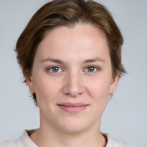 Joyful white young-adult female with short  brown hair and blue eyes