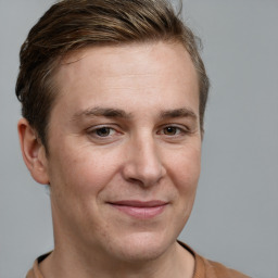 Joyful white adult male with short  brown hair and grey eyes