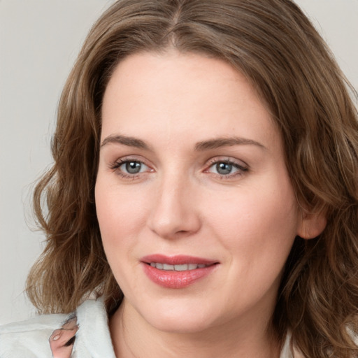 Joyful white young-adult female with medium  brown hair and green eyes