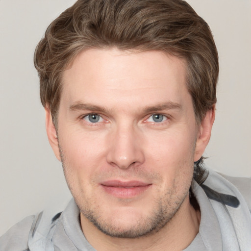 Joyful white adult male with short  brown hair and grey eyes