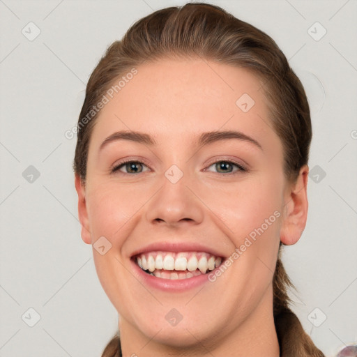 Joyful white young-adult female with short  brown hair and grey eyes