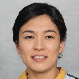 Joyful asian young-adult female with short  black hair and brown eyes