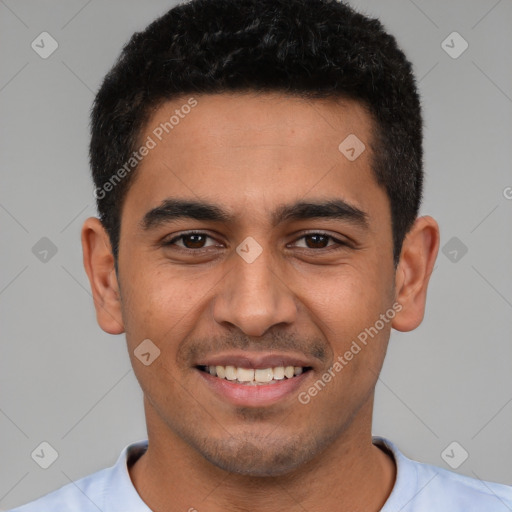 Joyful latino young-adult male with short  black hair and brown eyes