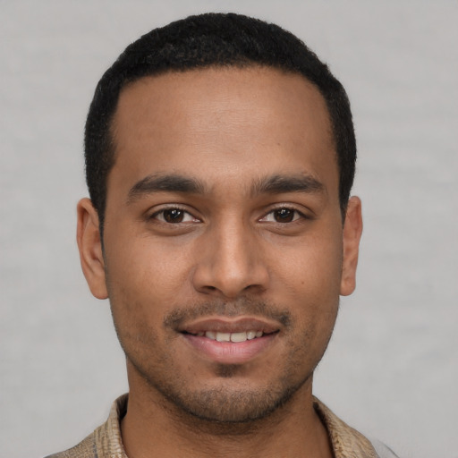 Joyful latino young-adult male with short  black hair and brown eyes