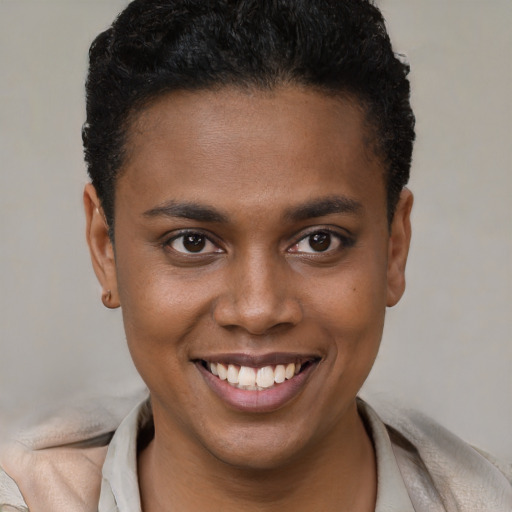 Joyful black young-adult female with short  brown hair and brown eyes