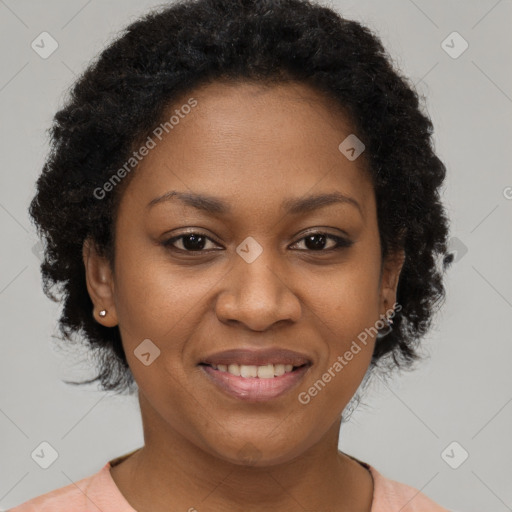 Joyful black adult female with short  brown hair and brown eyes