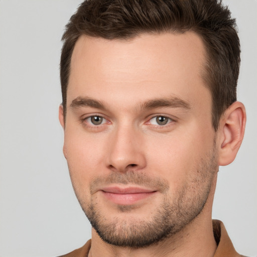 Joyful white young-adult male with short  brown hair and brown eyes