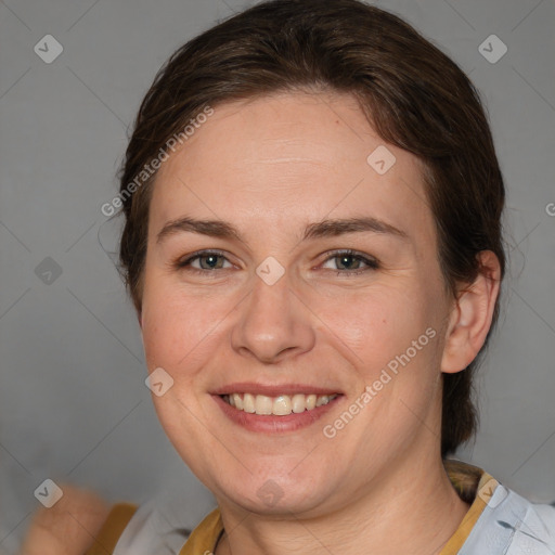 Joyful white adult female with medium  brown hair and blue eyes