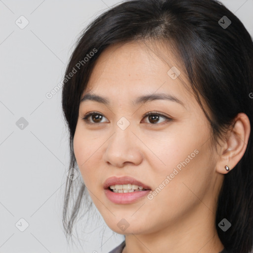 Joyful asian young-adult female with long  brown hair and brown eyes