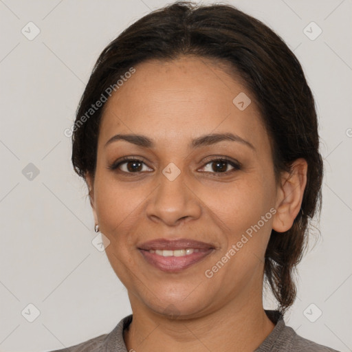 Joyful latino adult female with medium  brown hair and brown eyes