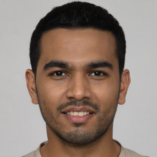 Joyful latino young-adult male with short  black hair and brown eyes