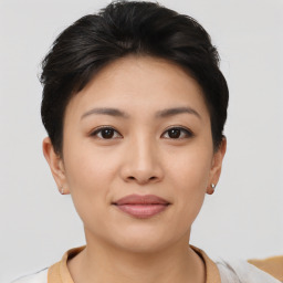 Joyful asian young-adult female with short  brown hair and brown eyes