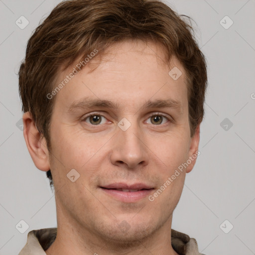 Joyful white adult male with short  brown hair and grey eyes