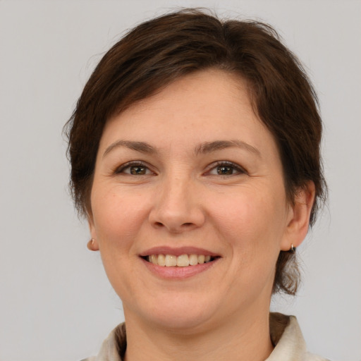 Joyful white adult female with medium  brown hair and brown eyes