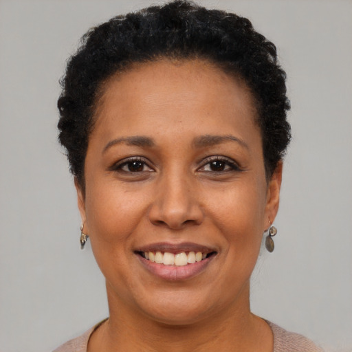 Joyful black adult female with short  brown hair and brown eyes