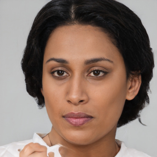 Neutral latino young-adult female with medium  black hair and brown eyes