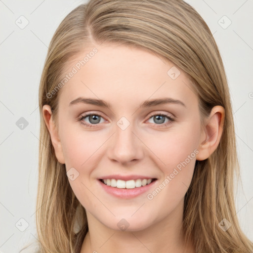 Joyful white young-adult female with long  brown hair and blue eyes