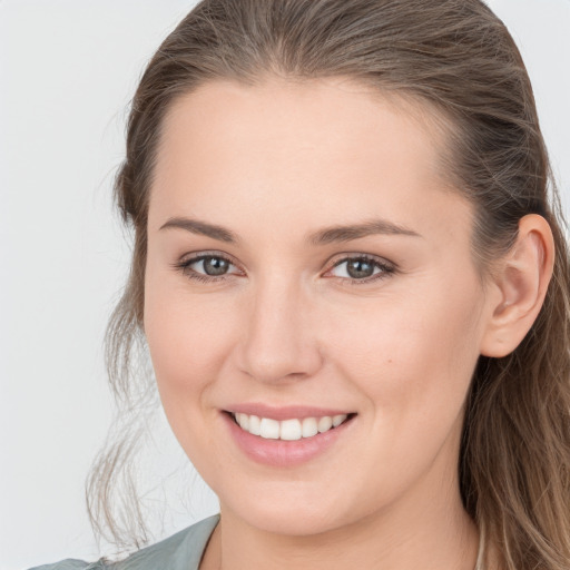 Joyful white young-adult female with long  brown hair and grey eyes