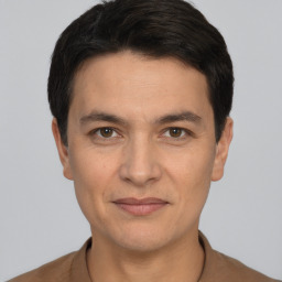Joyful white young-adult male with short  black hair and brown eyes
