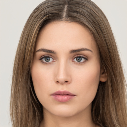 Neutral white young-adult female with long  brown hair and brown eyes