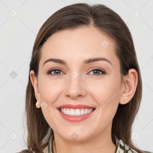 Joyful white young-adult female with long  brown hair and grey eyes