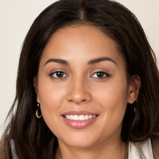 Joyful white young-adult female with long  brown hair and brown eyes