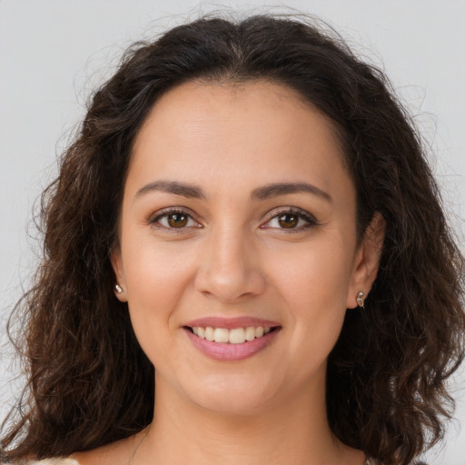 Joyful white young-adult female with long  brown hair and brown eyes