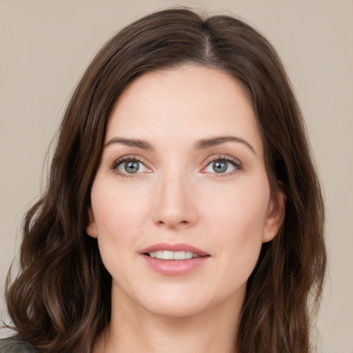 Joyful white young-adult female with long  brown hair and green eyes