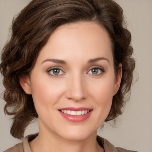 Joyful white young-adult female with medium  brown hair and green eyes