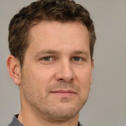 Neutral white adult male with short  brown hair and grey eyes