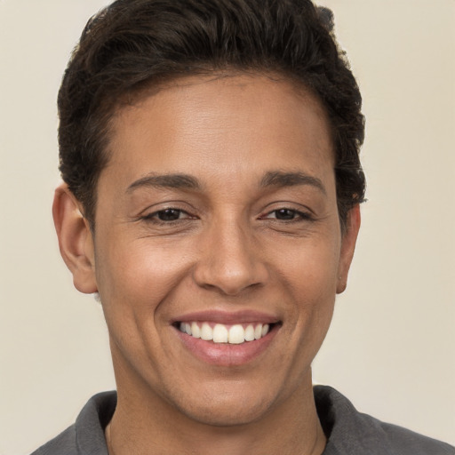 Joyful white young-adult female with short  brown hair and brown eyes