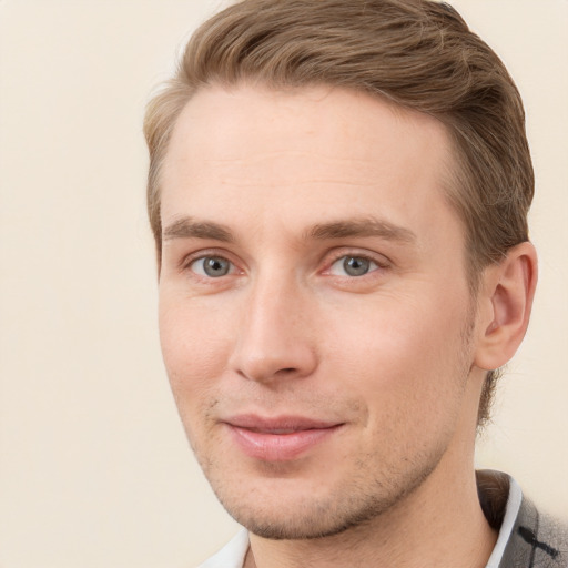 Joyful white young-adult male with short  brown hair and grey eyes