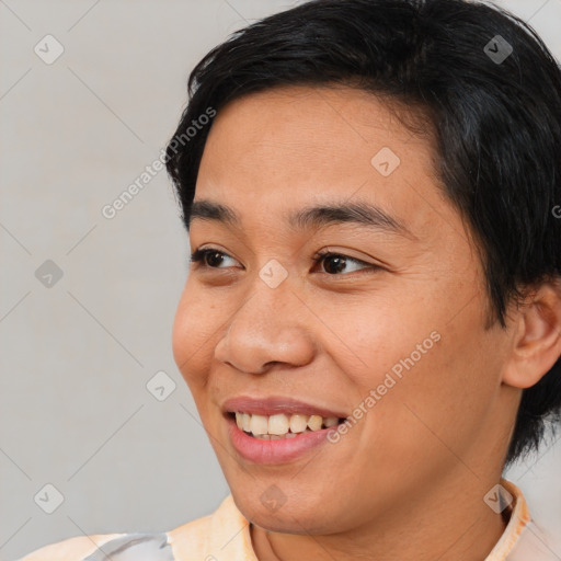 Joyful asian young-adult female with short  brown hair and brown eyes