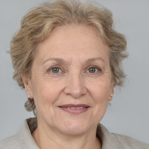 Joyful white middle-aged female with medium  brown hair and blue eyes