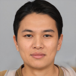 Joyful asian young-adult male with short  black hair and brown eyes