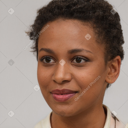 Joyful black young-adult female with short  brown hair and brown eyes