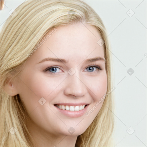 Joyful white young-adult female with long  brown hair and blue eyes