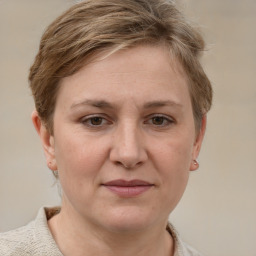 Joyful white adult female with short  brown hair and grey eyes