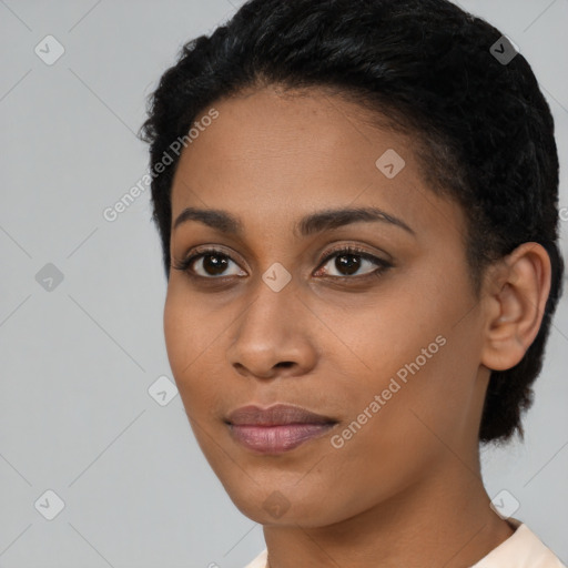 Joyful black young-adult female with short  black hair and brown eyes