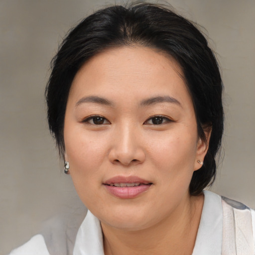 Joyful asian young-adult female with medium  brown hair and brown eyes