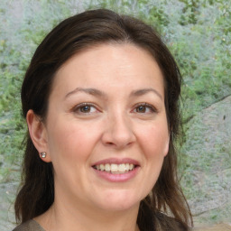 Joyful white adult female with medium  brown hair and brown eyes