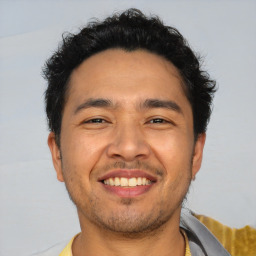 Joyful asian young-adult male with short  brown hair and brown eyes