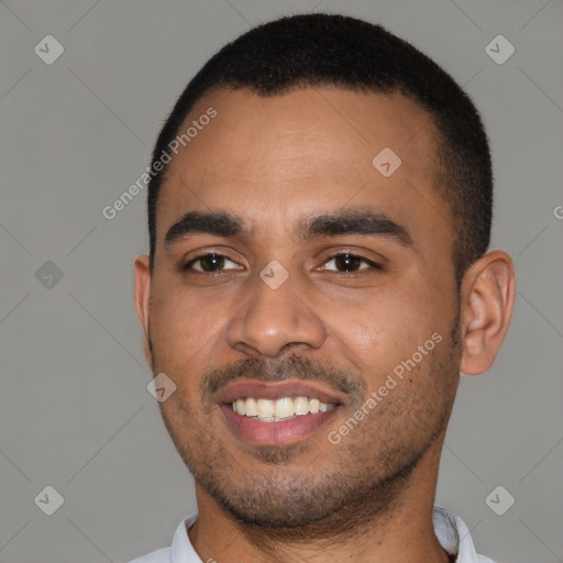 Joyful black young-adult male with short  black hair and brown eyes