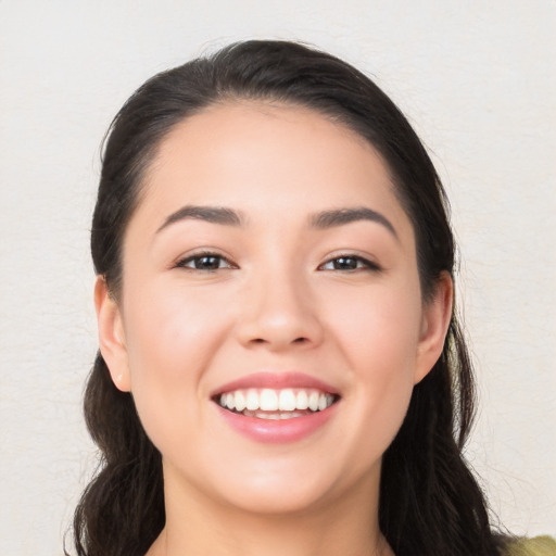 Joyful white young-adult female with long  black hair and brown eyes